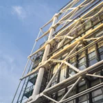 low-angle-view-modern-building-construction-blue-sky-sunlight